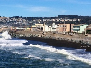 A distant view of the breach in the Beach Boardwalk seawall. It was originally built in two phases, from 1985 to 1988.